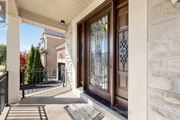 Close-up view of the covered porch and the ornate double front doors of the house. - 30 Fairmont Ridge Trail, King
