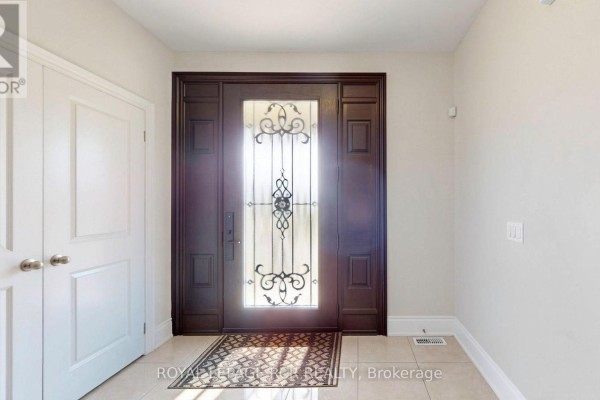 Interior view of the entryway with a closed door, a large wooden front door, and tiled floor. - 30 Fairmont Ridge Trail, King