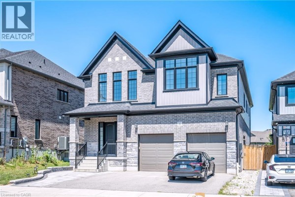 Close-up of the front entrance with stone and brick facade, dark door, and porch. - 30 Falconridge Drive Unit# Upper, Kitchener