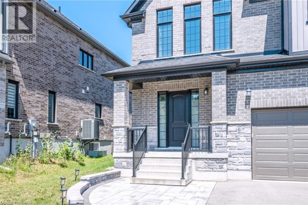 Front view of a large, modern residential house with light grey brick and grey siding. - 30 Falconridge Drive Unit# Upper, Kitchener