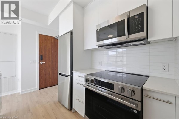 Close up of stainless steel refrigerator and modern kitchen appliances. - 30 Francis Street S Unit# 602, Kitchener
