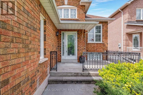 Aerial view of a backyard with a brick house, deck, and patio. - 30 Graceview Court, Vaughan