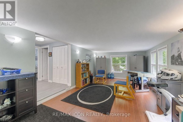 Spacious room with light blue walls, hardwood floors, a large rug, and various furniture including a desk and chairs. - 30 Grand Vista Crescent, Wellington North