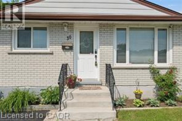 Close-up view of the front entrance with steps and decorative plants. - 30 Kimberly Road Unit# Upper Unit, Cambridge