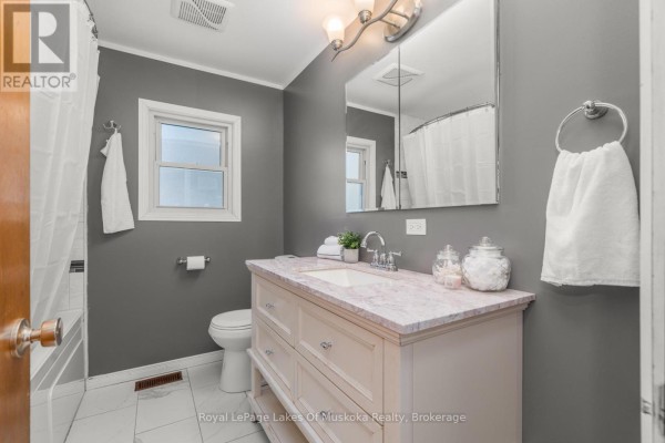 Bathroom with vanity, marble countertop, and tiled floors - 30 Kitchen Road S Huntsville