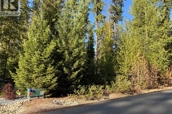 Electrical utility box near a treed lot with a gravel and rock border. - 30 Lusk Lake Road Lot# 73, Enderby