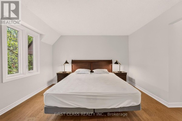 Bedroom with king bed, wooden headboard, bay window, and hardwood floors - 30 Ritter Crescent Markham