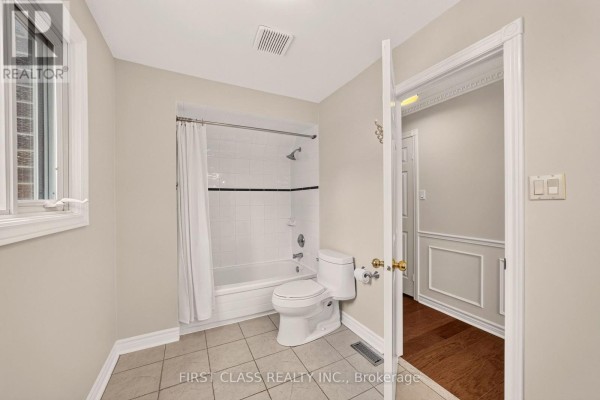 Bathroom with tub-shower, toilet, and tiled floor - 30 Ritter Crescent Markham