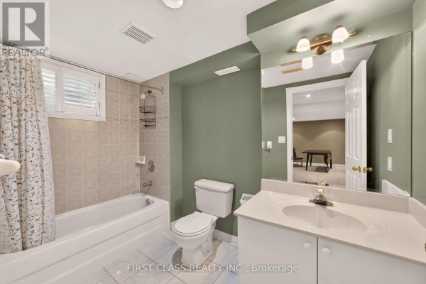 Bathroom with tub, toilet, vanity, and mirror - 30 Ritter Crescent Markham