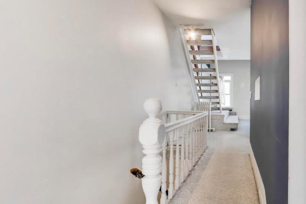 Hallway with carpeted stairs and white banister - 30 Robert Street Toronto