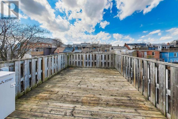 Wooden deck and fence with HVAC unit - 30 Robert Street Toronto
