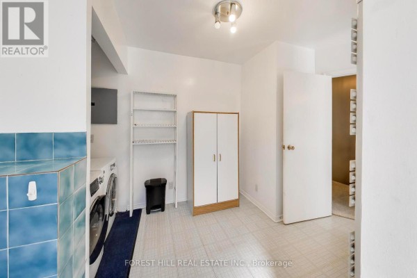 Washer, dryer, shelving, cabinet & blue tile backsplash - 30 Robert Street Toronto
