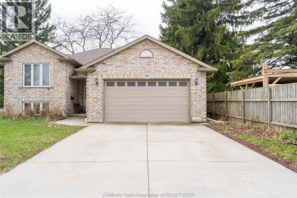 Front view of a brick house with a concrete driveway and a two-car garage. - 30 St Michael Avenue, Chatham