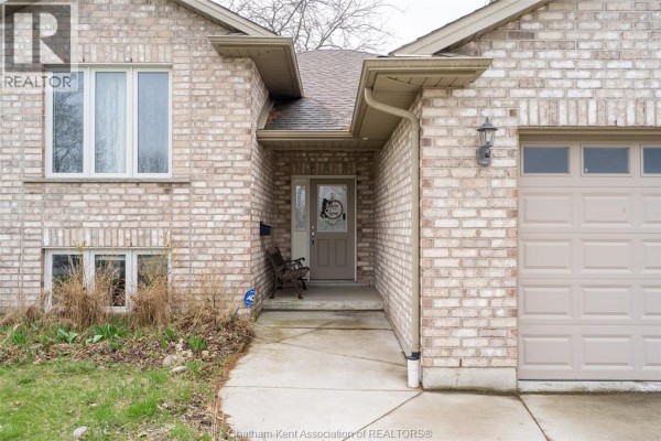 Close-up of the entrance to a brick house with a covered porch and garage. - 30 St Michael Avenue, Chatham