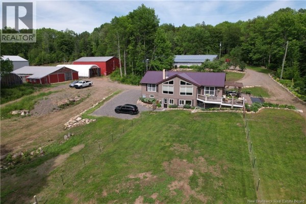Aerial view of a grey house with a purple roof, deck, and expansive rural property. - 30 Stillwater Road, Digdeguash