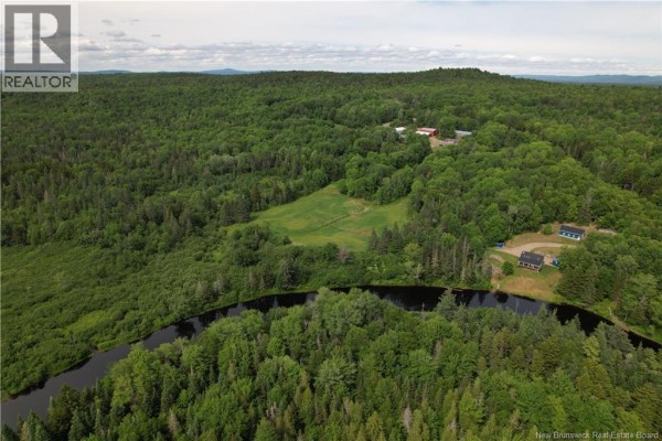 Aerial view of a rural property with fields, forest, and a body of water. - 30 Stillwater Road, Digdeguash
