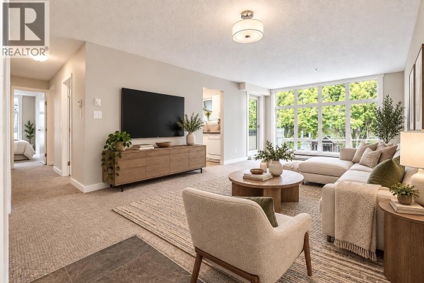Living room with sofa, armchair, TV, and view to hallway and bedroom. - 300 2533 Penticton Street, Vancouver