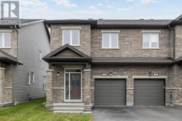 Front exterior of a brick townhouse with a dark brown front door. - 300 Livery Street, Ottawa