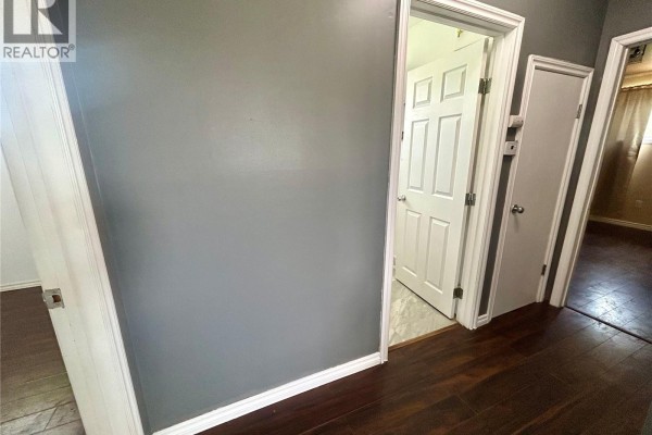 Interior hallway with dark hardwood floors and white doors. - 300 Main Street, Lang