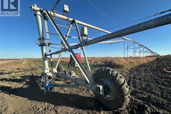 Close-up of a large metal irrigation system with wheels on a dirt field. - 300 Valley Road, Corman Park Rm No  344