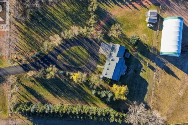 Aerial view of the property showing the house, surrounding land, and outbuildings. - 3000 35 Street, Ponoka
