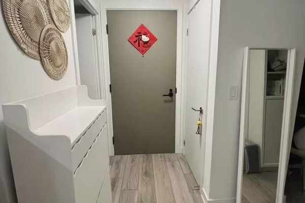 Apartment entryway with a white dresser, grey door with a red wall hanging, and a mirror. - 3001 - 47 Mutual Street, Toronto