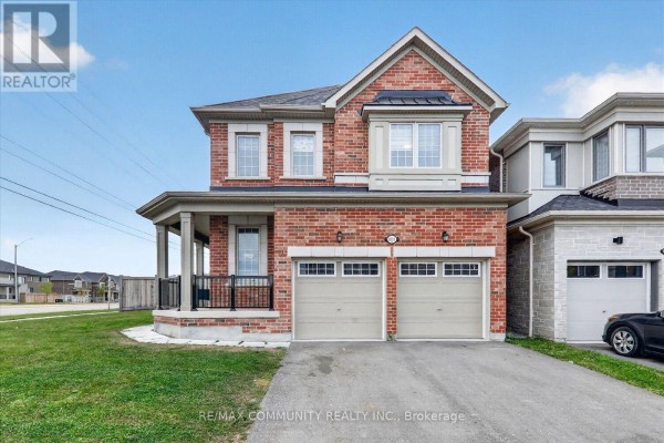 Front view of the brick house with a driveway, garage doors, and porch. - 3001 Hollyberry Trail, Pickering