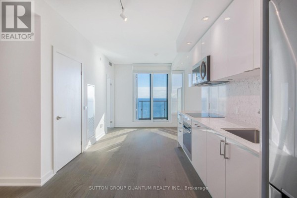 Open concept living area and kitchen with a view of Lake Ontario. - 3008 - 1926 Lake Shore Boulevard W, Toronto