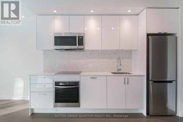 Modern white kitchen with stainless steel appliances and quartz countertops. - 3008 - 1926 Lake Shore Boulevard W, Toronto