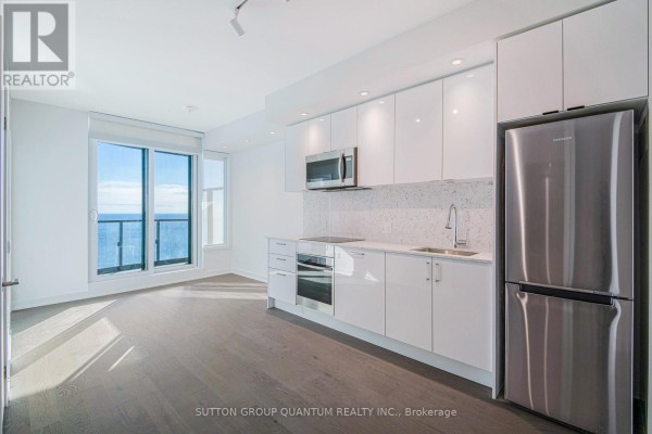 Bright kitchen and living area with light wood floors and lake view. - 3008 - 1926 Lake Shore Boulevard W, Toronto