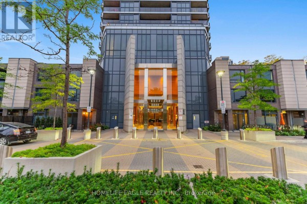 Exterior view of the modern apartment building entrance with glass doors and surrounding landscaping. - 3008 - 5 Valhalla Inn Road, Toronto