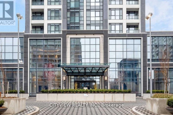 Exterior view of a building entrance with glass and stone. - 3009 - 7 Mabelle Avenue, Mississauga