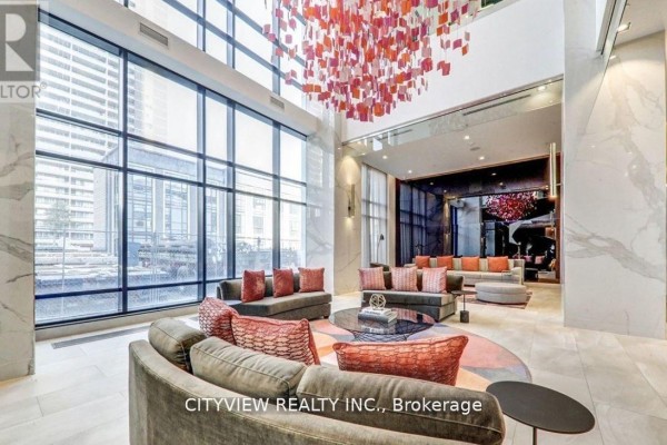Luxury lobby with sofas, marble accents, and a large art installation. - 3009 - 7 Mabelle Avenue, Mississauga
