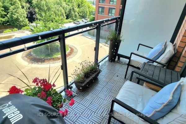 Balcony with seating, planters, grill cover, and string lights - 301 - 11611 Yonge Street Richmond Hill