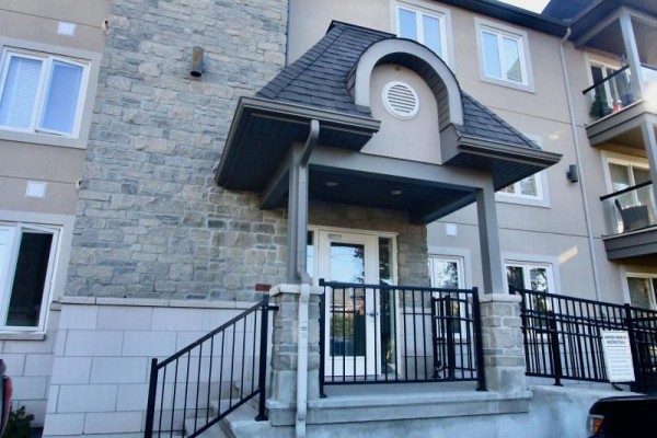 Entrance to the apartment building with stone facade and covered porch. - 301 - 2 Warner Street, Russell