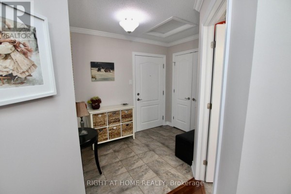 Apartment entryway with tiled floor, storage unit, and two doors. - 301 - 2 Warner Street, Russell