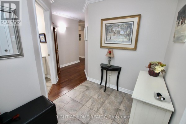 Hallway inside the apartment with wood floors, artwork, and furniture. - 301 - 2 Warner Street, Russell