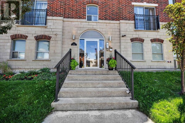 Concrete steps leading to the glass entrance of an apartment building with railings. - 301 - 34 Brock Street, Woodstock