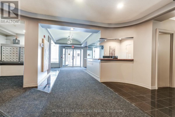 Lobby with reception desk, mailboxes, and security entrance - 301 - 483 Faith Drive Mississauga