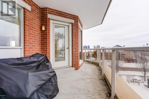 Balcony with glass railing and brick exterior - 301 - 483 Faith Drive Mississauga