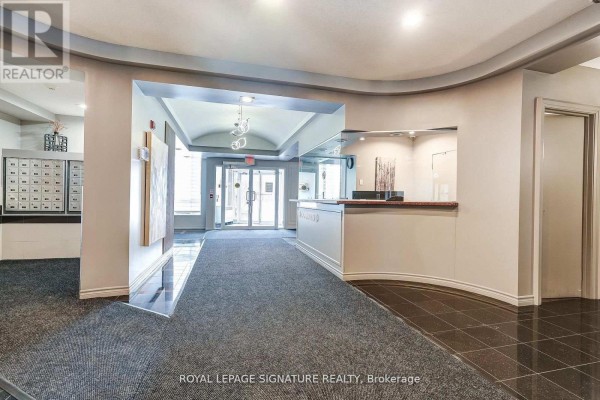 Kitchen with granite countertops, stainless steel appliances, and wood cabinetry. - 301 - 483 Faith Drive, Mississauga