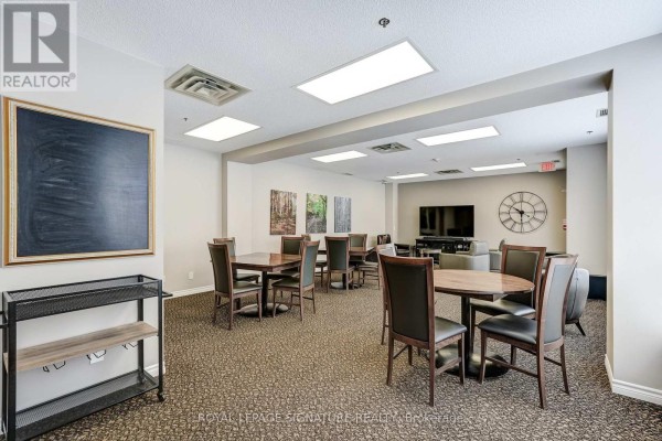 Dining tables, TV, clock, and chalkboard - 301 - 483 Faith Drive Mississauga