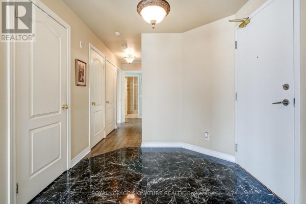 Hallway with marble and hardwood floors, interior doors - 301 - 483 Faith Drive Mississauga