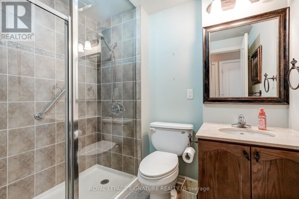 Glass shower, vanity, and toilet in bathroom - 301 - 483 Faith Drive Mississauga