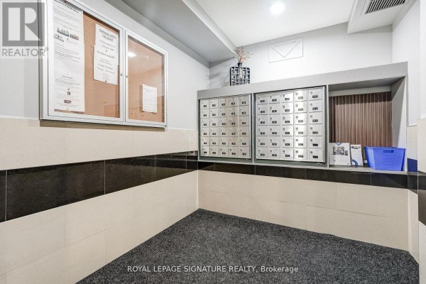 Bedroom with hardwood floors, a large window, and a tray ceiling. - 301 - 483 Faith Drive, Mississauga