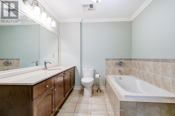 Bathroom with double vanity, large mirror, and bathtub - 301 - 483 Faith Drive Mississauga