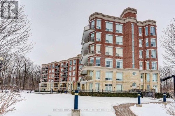 Brick condo building with balconies and stone accents - 301 - 483 Faith Drive Mississauga
