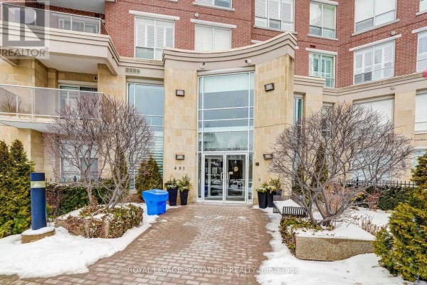 Modern building entrance with brick and stone facade, glass doors and windows - 483 Faith Drive Mississauga