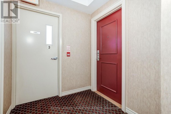 Hallway with red door 301 and cream door 3 with window - 301 - 483 Faith Drive Mississauga