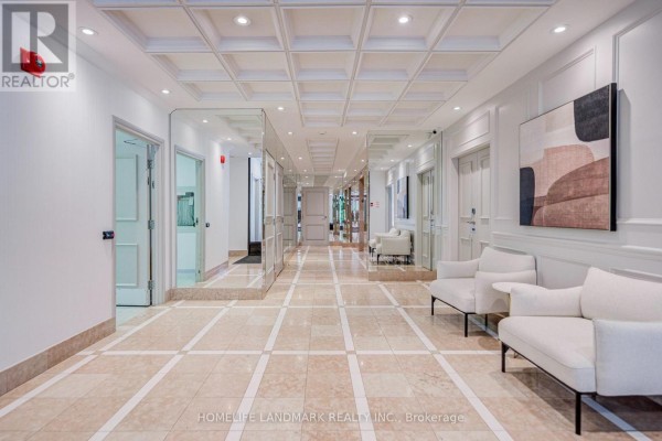 A well-lit apartment building hallway with marble tile floors, white seating, and mirrored walls. - 301 - 96 Fifeshire Road, Toronto